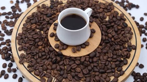 Coffee Cup Surrounded by Beans, Close Up