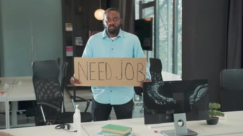 In Office Unemployed African American Businessman Holding Poster Cardboard with Need Job Jobless