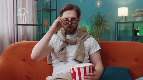 Man Enjoys 3D Movie with Popcorn