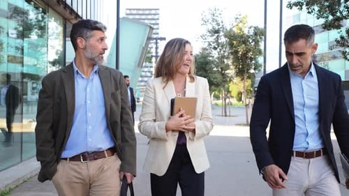 Business Colleagues Walking and Talking Near Office Building