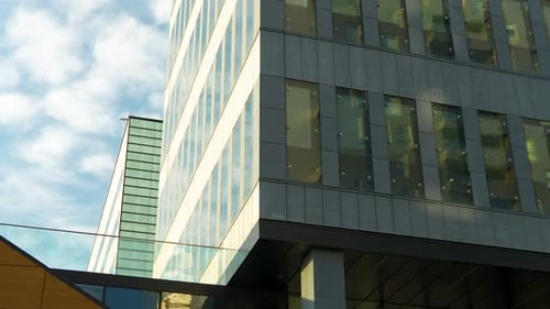 Sky view framed by modern architectural elements and the edge of a building.
