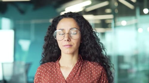 Woman Talking Wearing Glasses in Modern Office