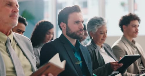 Diverse Attendees Actively Listening and Taking Notes