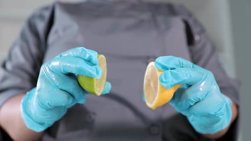 Slow motion lemon and lime being squeezed