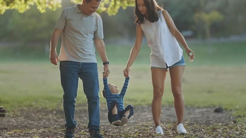 Cute Young Family Walking in the Park