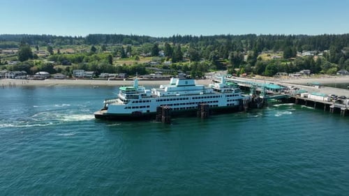 Drone shot pulling away from a docked Washington State ferry.