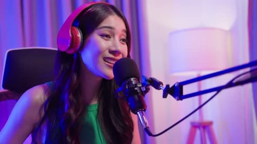 Woman Speaking Into Microphone With Headphones