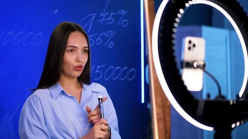 Engaging Woman Explaining Business Data For Online Broadcast