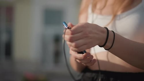 Youthful Performer Prepares for Dance Street Dancer Adjusting Wired Headphones Thoroughly Closeup of