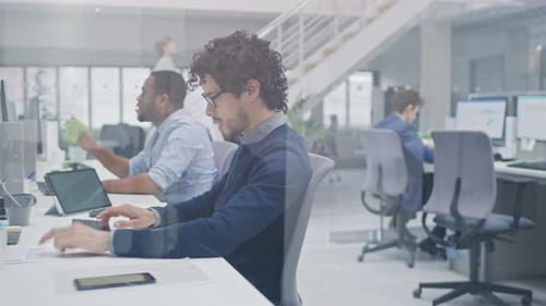 Busy Professionals Working at Computers in Modern Office