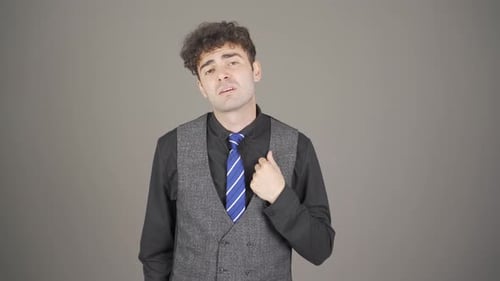 Young Adult Speaking in Front of Gray Background