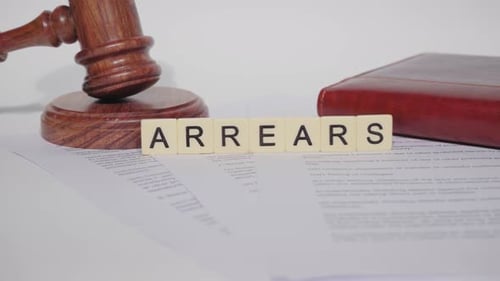 Gavel and "Arrears" Letters on Legal Document