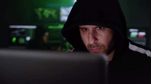 Man Wearing Hoodie Focused on Computer Screen