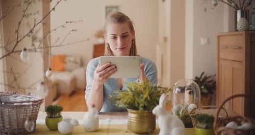Woman Browsing Tablet Social Media During Easter Holidays
