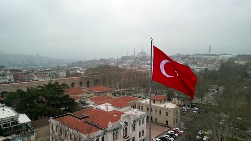 Cityscape View with Large Flag Waving