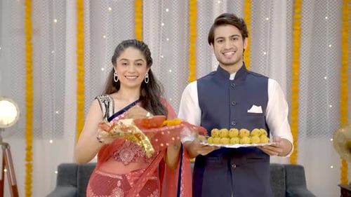 Smiling Couple with Diwali Offerings
