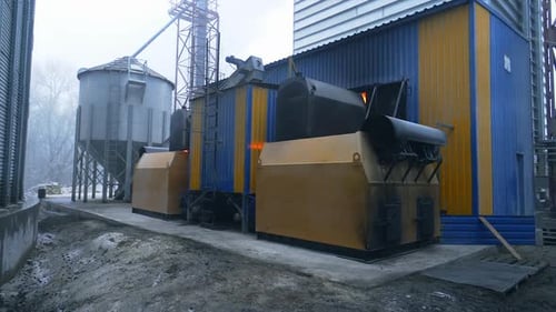 Exterior of Rural Industrial Building with Silos and Machinery