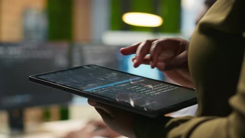Close Up of Engineer Using Tablet to Write Code Developing Machine Learning API