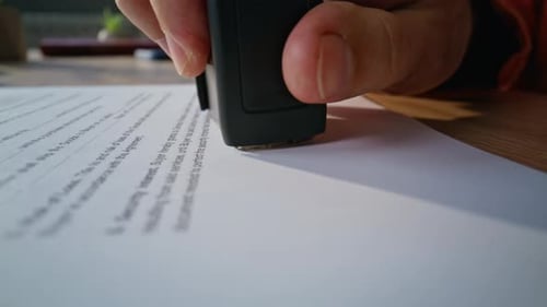 Hand Stamping Business Contract Placed on Workspace Closeup Unknown Businessman