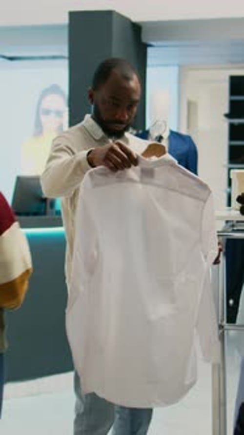Man Shopping for Dress Shirts at Clothing Store