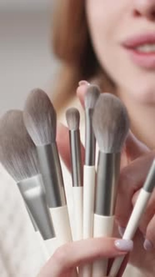 Woman Holding Make-Up Brushes Close Up