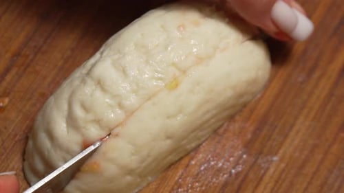 Close up of cheese block being sliced