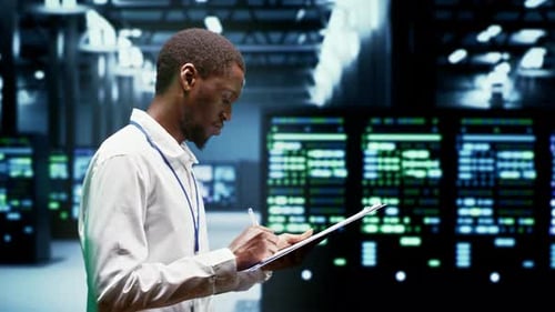 Man Taking Notes in Data Center