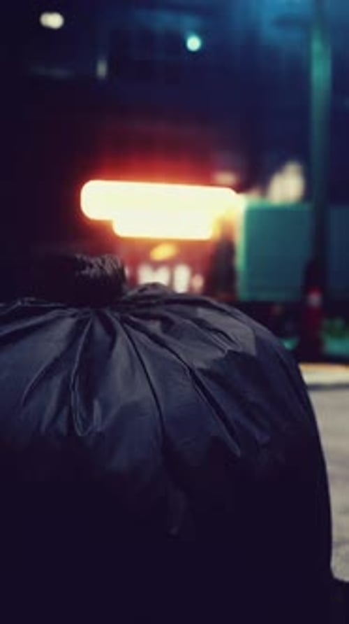 A Garbage Bag Sitting on the Ground in Front of a Building