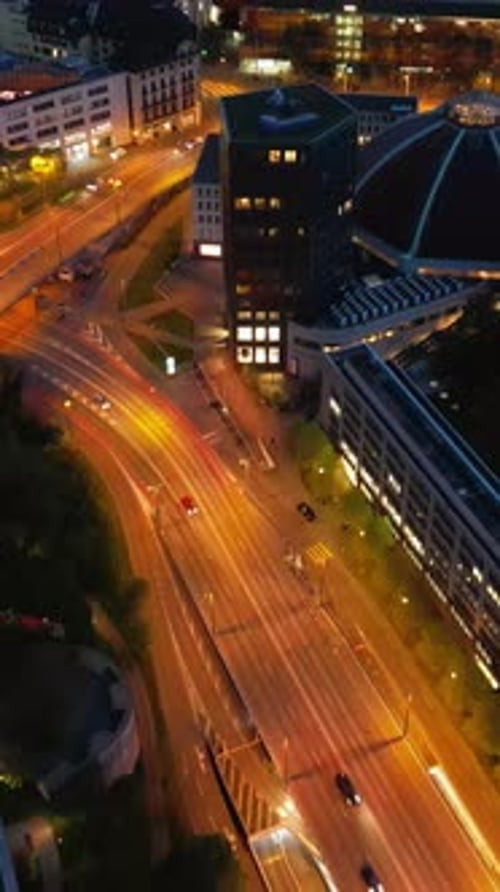 Aerial, drone view of the streets of Basel, Switzerland in the evening. Vertical