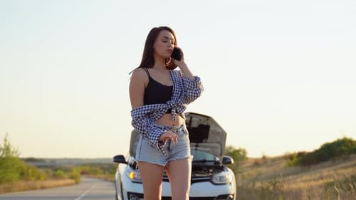Woman Calling for Help with Car Trouble on Road