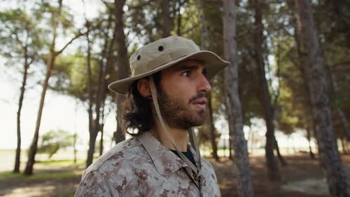 Man in Camouflage Saluting in Forest