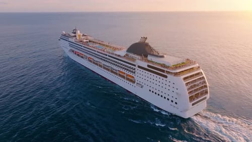 Explore a luxury cruise ship sailing across the vast ocean at sunset