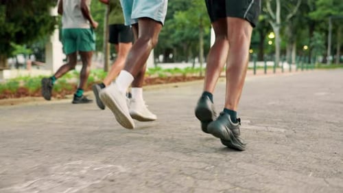 Group, legs and running for cardio, fitness and wellness in park for urban marathon club