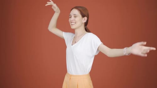 Woman with Auburn Hair Dancing Happily