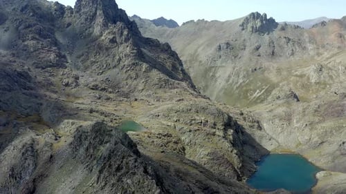 Aerial Flying Over Rocky Mountain With Glacial Lakes