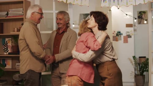 Family Celebrates Birthday with Hugs and Handshakes