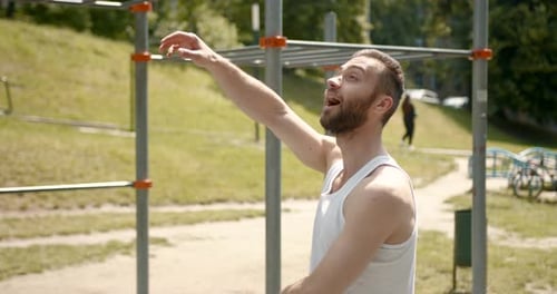 Man Stretching Arms Outdoors on a Sunny Day
