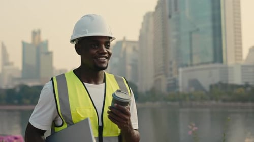 Portrait of African Amerian Foreman with Laptop and Coffee in City