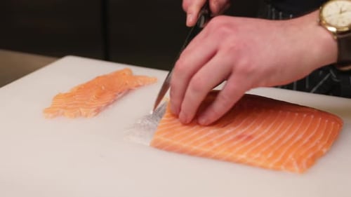 Close Up of Chef Slicing Fresh Salmon Fillet