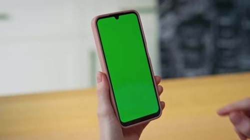 Hand Holding Cell Phone With Green Screen