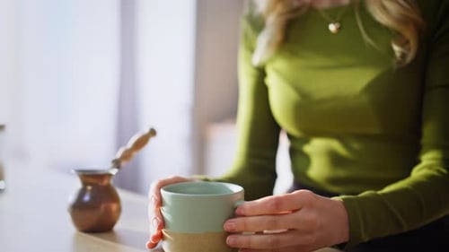 Woman Pours Coffee and Enjoys the Aroma