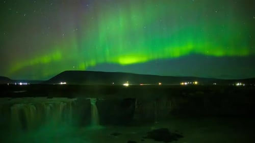 Aurora over waterfall in Iceland.