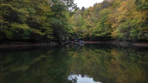 Perfect Autumn Forest Reflection on a Calm, Still Lake Water