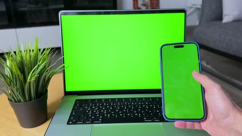 Modern Green Screen Setup with Laptop and Smartphone for Seamless Editing.