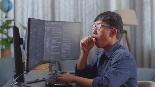 Asian Boy Programmer Yawning While Creating Innovative Software ...