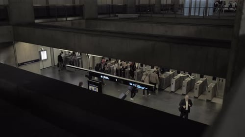 A top view of people walking through automatic turnstiles