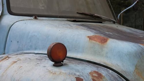 Rusty indicator on blue vintage truck