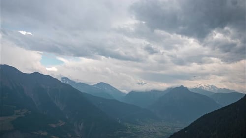 timelapse footage of a rain storm passing over high mountains in the Swiss alps in the canton of Val