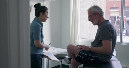 Healthcare Professional Consults with Mature Adult Patient