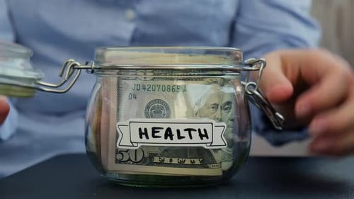 Female Hands Take Money From Glass Jar Full of American Currency Dollars Cash Banknote with Text